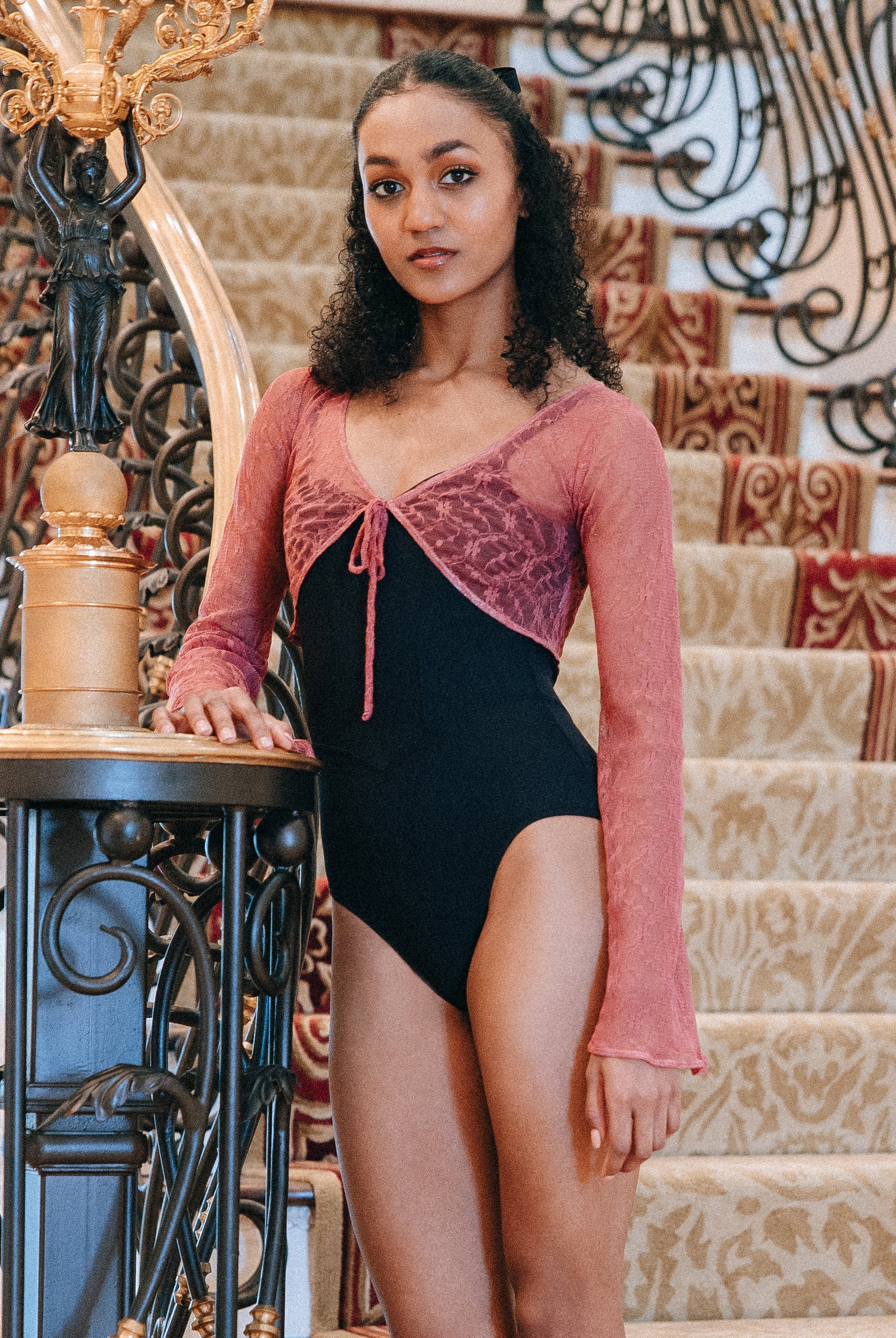 Model wearing pink, Lace tie-front cropped top with long bell sleeves.